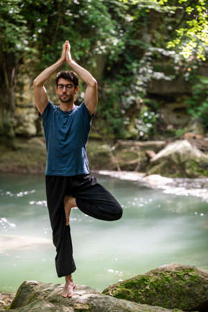 boy doing yoga in the woods bareback in tranquilityの写真素材