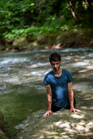 boy doing yoga in the woods bareback in tranquilityの写真素材
