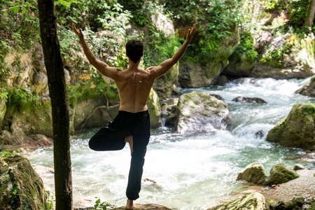 boy doing yoga in the woods bareback in tranquilityの写真素材