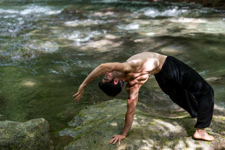 boy doing yoga in the woods bareback in tranquility