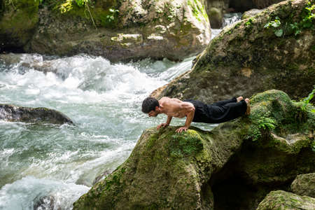 boy doing yoga in the woods bareback in tranquilityの写真素材