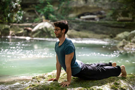boy doing yoga in the woods bareback in tranquilityの写真素材
