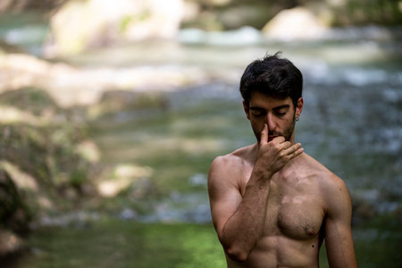 boy doing yoga in the woods bareback in tranquilityの写真素材