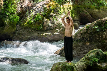 boy doing yoga in the woods bareback in tranquilityの写真素材