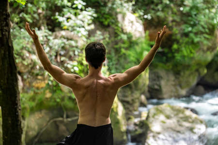 boy doing yoga in the woods bareback in tranquilityの写真素材