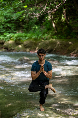 boy doing yoga in the woods bareback in tranquilityの写真素材