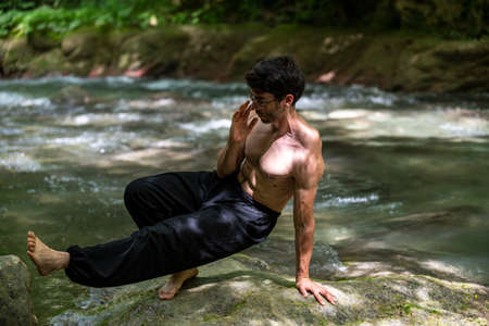 boy doing yoga in the woods bareback in tranquilityの写真素材