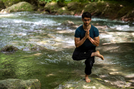 boy doing yoga in the woods bareback in tranquilityの写真素材