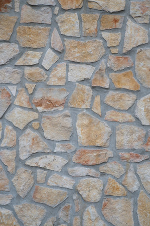 texture of an exterior stone wall of a residenceの写真素材