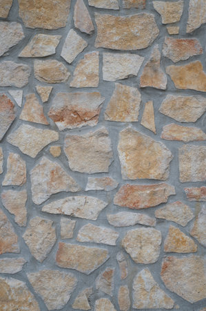 texture of an exterior stone wall of a residenceの写真素材