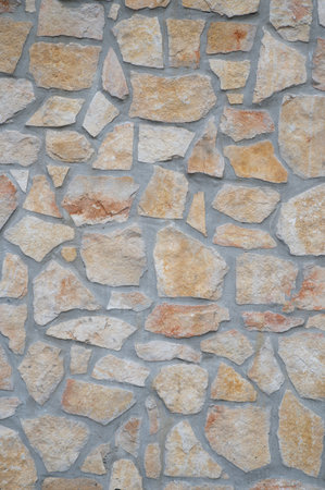 texture of an exterior stone wall of a residenceの写真素材
