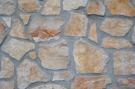 texture of an exterior stone wall of a residenceの写真素材