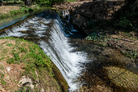 Menotre Waterfalls in the town of Pale, Perugia province, surrounded by nature during the summer.の写真素材