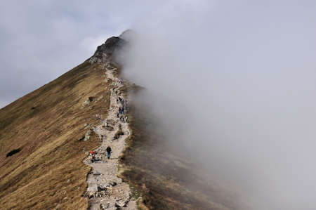Hiking in Tatra Mountains  in autumn, foggy day.