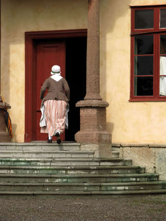 Stockholm, Sweden, August 30, 2010 - Lady dressed in historic clothes in house in Skansen