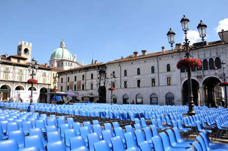 Brescia, Italy, July 21, 2011 - Rows of blue chairs prepared for the concert in historical centre of Bresciaのeditorial素材