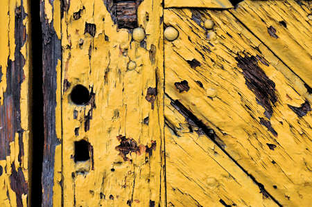 Old yellow wooden door with key holeの写真素材
