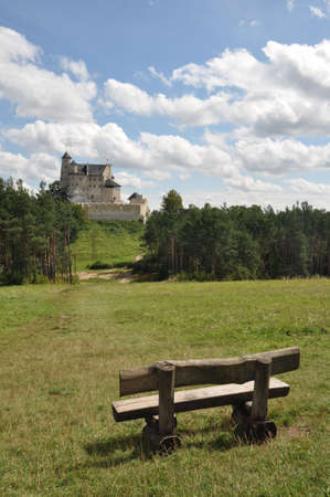 View of Bobolice castle seen from the distance, bench for tourists on the first planの写真素材