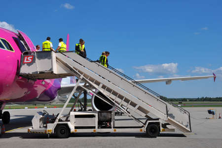 KATOWICE - JULY 2: Cabin crew staff leaving the Wizzair Airbus A320 after the landing on July 2, 2015 in Katowice Airport, Poland. Wizzair is one of the largest low-cost airlines.のeditorial素材