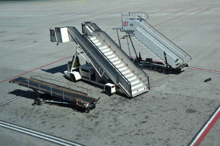 KATOWICE - JULY 2: Movable ramp parked on the airport field, waiting for the landing of a plane on July 2, 2015 in Katowice Airport, Poland.のeditorial素材