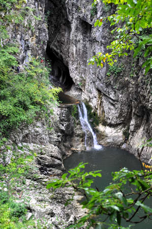 Natural cave entrance carved into stone by Reka river. View at one of the three touristic paths in karst area of Skocjan cave Slovenia.の写真素材