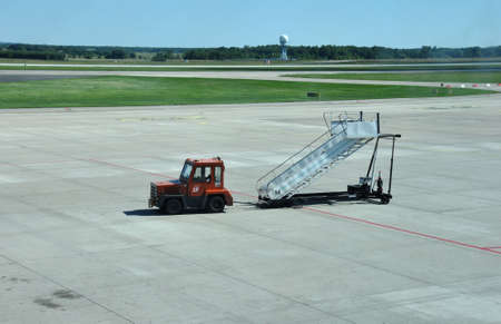 KATOWICE - JULY 2: Car with movable ramp on its way to the plane just after the landing on July 2, 2015 in Katowice Airport, Poland.のeditorial素材