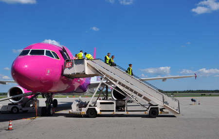 KATOWICE - JULY 2: Cabin crew staff leaving the Wizzair Airbus A320 after the landing on July 2, 2015 in Katowice Airport, Poland. Wizzair is one of the largest low-cost airlines.のeditorial素材