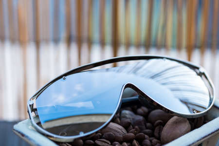 Oversized sunglasses model with big lenses and metal framereflecting the sun closeup.Selective focusの写真素材