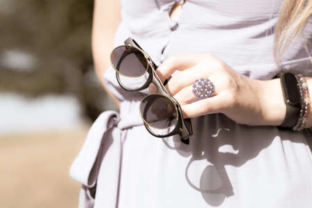 Black steampunk sunglasses with round lenses flip up retro model close up shoot in a summer day....