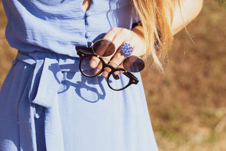Black steampunk sunglasses with round lenses flip up retro model close up shoot in a summer day. Selective focusの写真素材