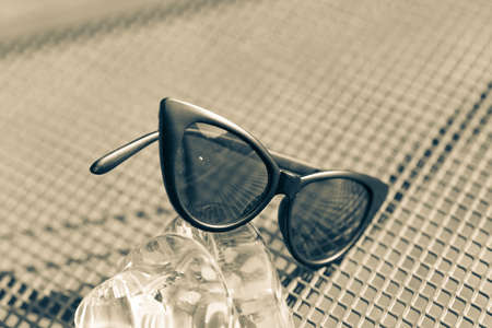 Cat eye sunglasses black model shoot in a summer day closeup. Selective focusの写真素材