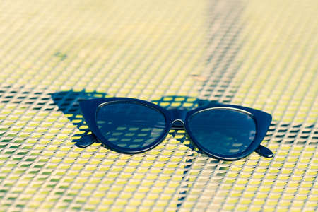 Cat eye sunglasses black model shoot in a summer day closeup. Selective focusの写真素材