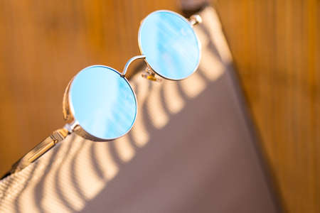 Steampunk sunglasses model with round lenses in a summer day closeup. Selective focus