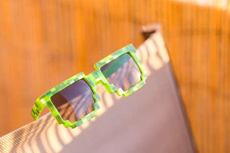 Green thug life pixel model sunglasses shoot outside in a sunny day closeup. Selective focusの写真素材