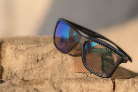 Classic Sunglasses model shoot in a urban place in a summer day. Selective focus