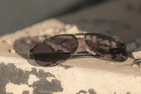 Aviator Sunglasses shoot in a urban place in a summer day closeup. Selective Focus