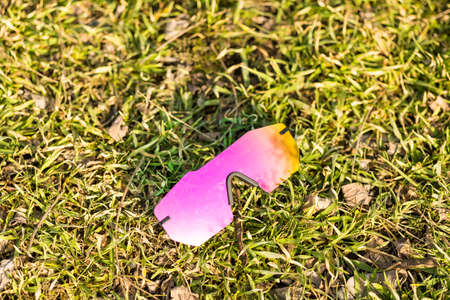 Futuristic sunglasses model rimless with big pink lens reflecting the sun in a summer day closeup. Selective focusの写真素材
