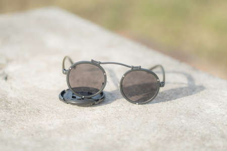 Steampunk model sunglasses with big round lens shoot outside in a summer day closeup. Selective Focusの写真素材