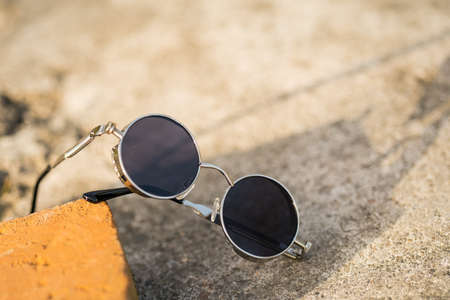 Steampunk sunglasses model with black lenses shoot outside in a summer day closeup. Selective Focusの写真素材