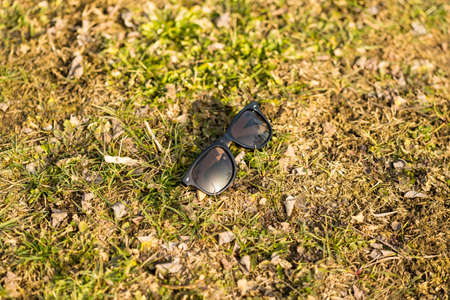 Classic sunglasses model with black lenses shoot outside in the nature closeup. Selective focusの写真素材