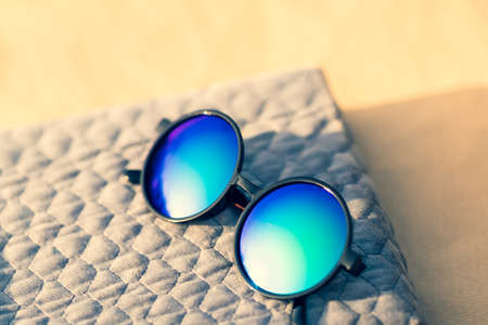 Sunglasses with big blue round lens shoot outdoors in a sunny day closeup. Selective Focusの写真素材