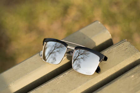Classic sunglasses model with silver lenses shoot in a sunny day closeup . Selective focusの写真素材