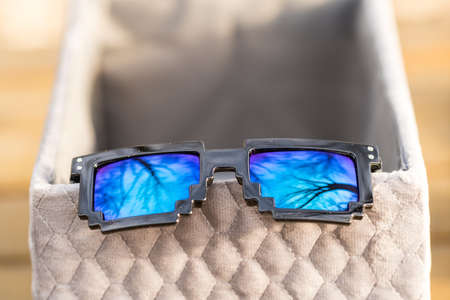 Black pixel sunglasses with blue lensesの写真素材