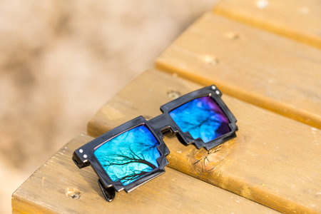 Black pixel sunglasses with blue lensesの写真素材