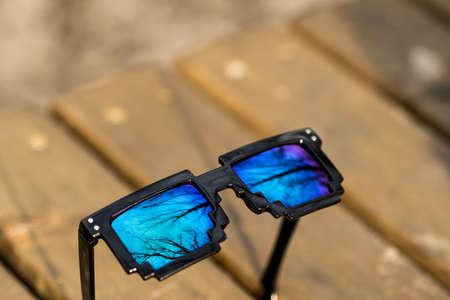 Black pixel sunglasses with blue lensesの写真素材
