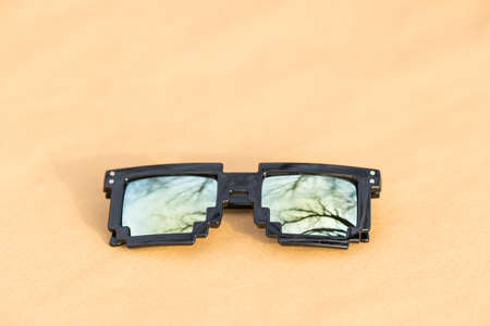 Pixel sunglasses model with yellow lenses and black frame shoot in a summer day closeup. Selective focusの写真素材