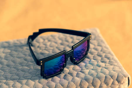 Pixel sunglasses model with blue lenses and black frame closeup in a sunny day. Selective focusの写真素材