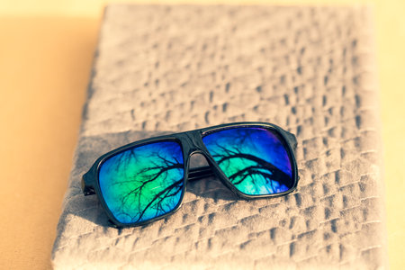 Classic Sunglasses model with green lenses shoot outside place in a summer day. Selective focusの写真素材