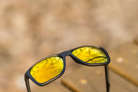 Classic Sunglasses design with golden lenses shoot outside in a summer day closeup. Selective focusの写真素材