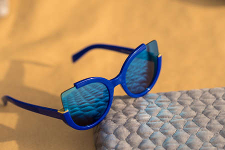 Cat eye sunglasses special model for women with blue lenses shoot outside in a sunny day closeup. Selective focusの写真素材